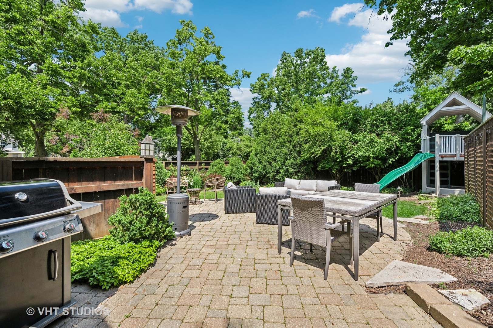 720 Willow Road Winnetka, IL 60093 - Photo 21 of 28 a view of a chairs and table in the back yard of a house