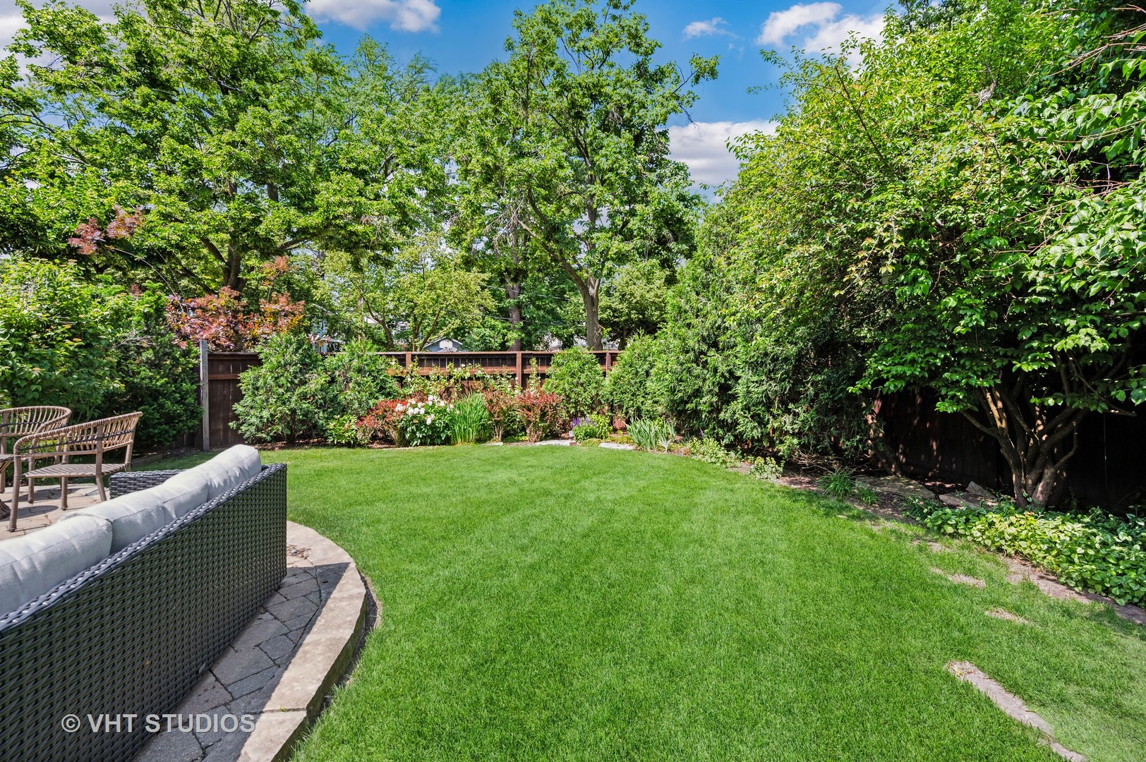720 Willow Road Winnetka, IL 60093 - Photo 22 of 28 a view of a backyard with couches plants and large trees