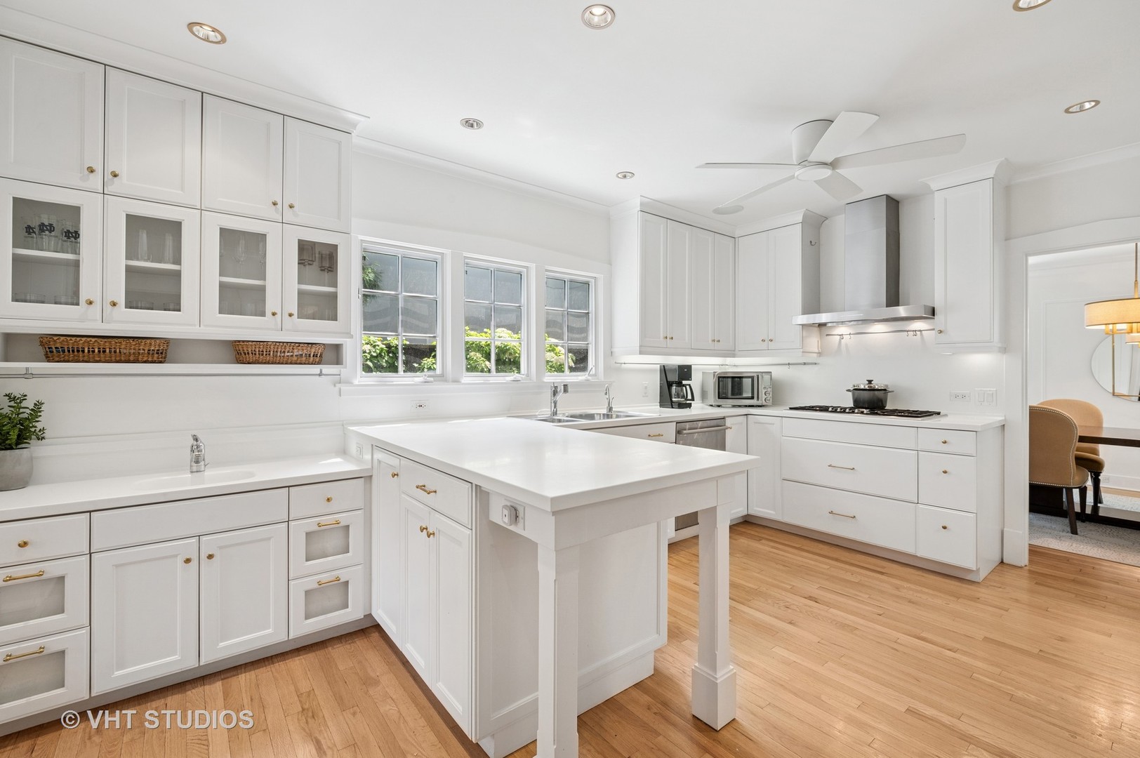 720 Willow Road Winnetka, IL 60093 - Photo 4 of 28 a kitchen with granite countertop white cabinets and white appliances