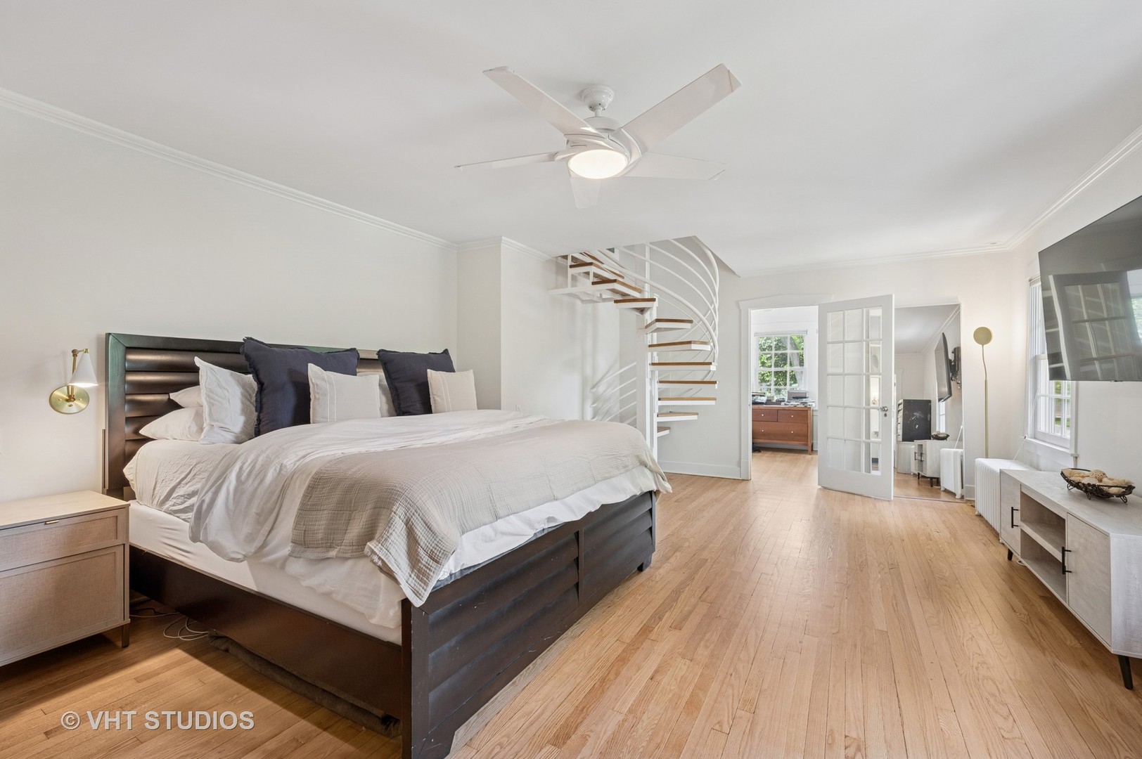720 Willow Road Winnetka, IL 60093 - Photo 9 of 28 a spacious bedroom with a bed and a flat tv screen on the dresser