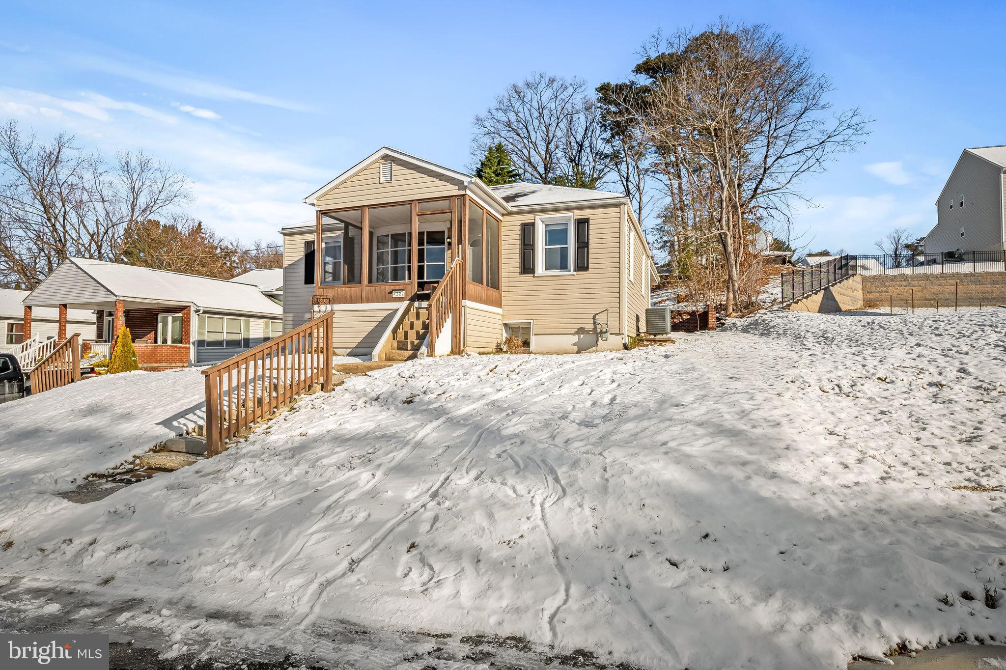 Charming home nestled in a snowy landscape.
