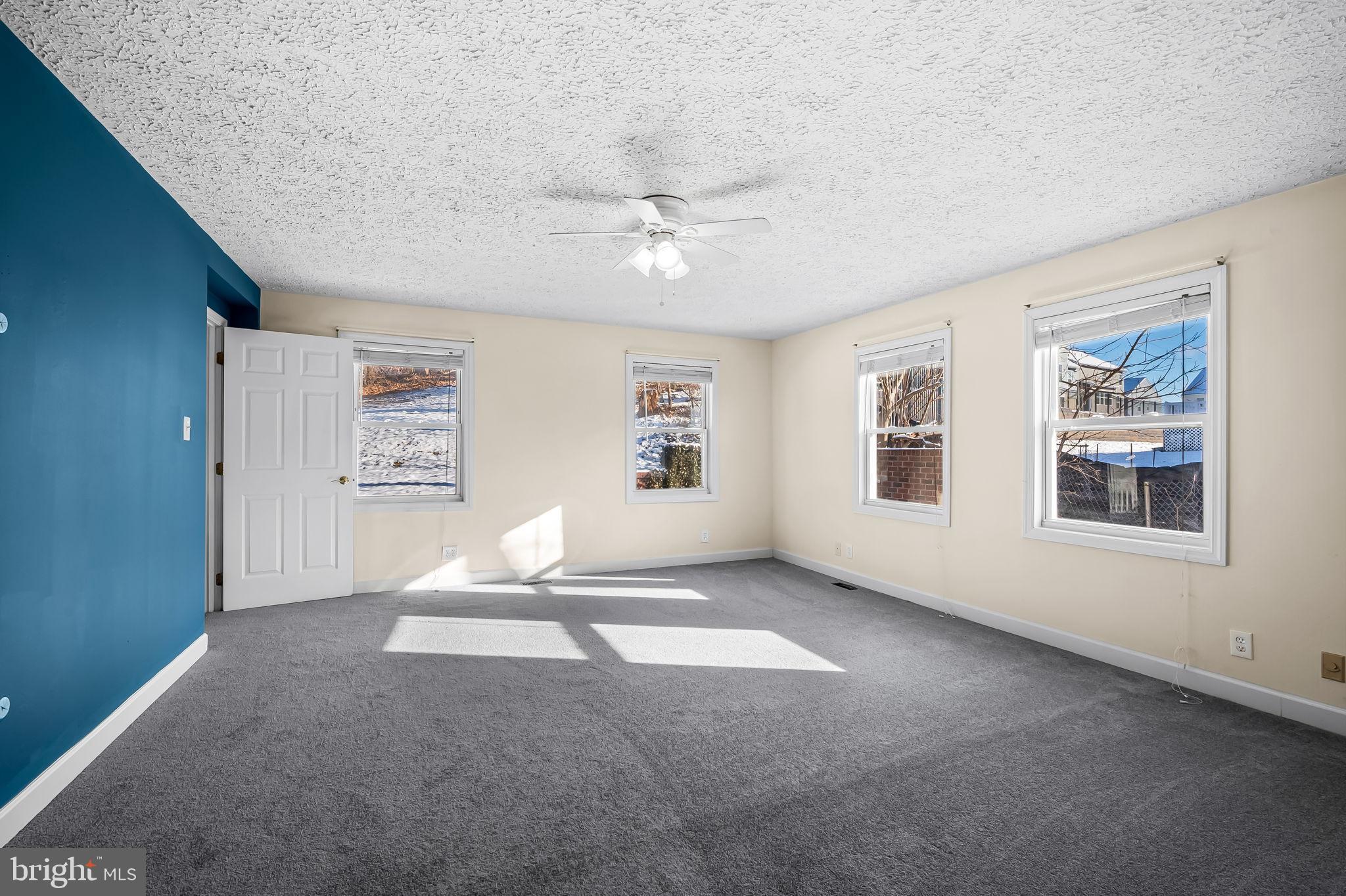 4222 Klosterman Avenue Nottingham, MD 21236 - Photo 20 of 43 an empty room with windows and ceiling fan