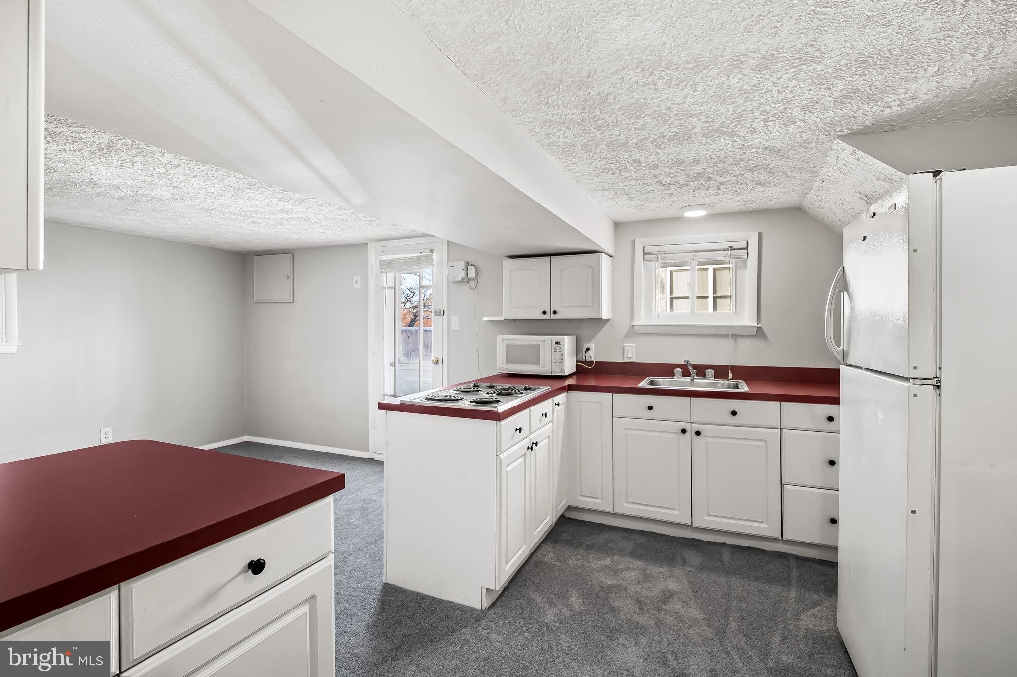 4222 Klosterman Avenue Nottingham, MD 21236 - Photo 27 of 43 a kitchen with cabinets and wooden floor