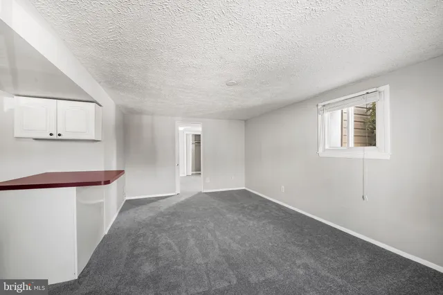 an empty room with windows and closet