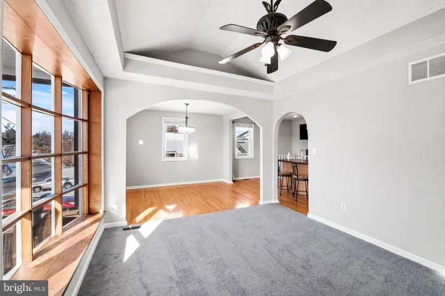 a view of a livingroom with a ceiling fan and window