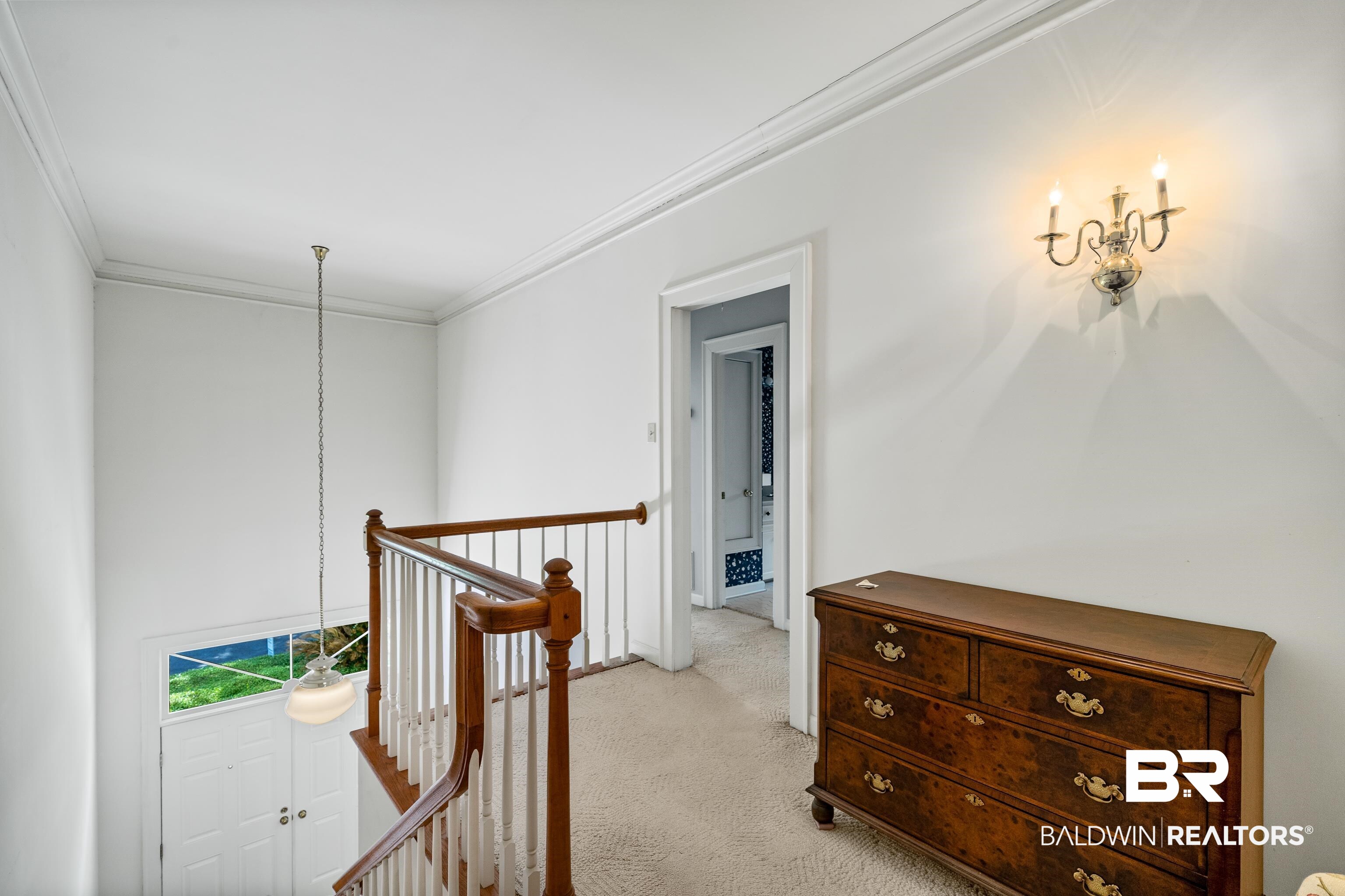 4272 Bit And Spur Road, Unit 12 Mobile, AL 36608 - Photo 6 of 34 Hall featuring an upstairs landing, crown molding, light carpet, and baseboards