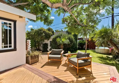 a view of a chairs and table in backyard of the house