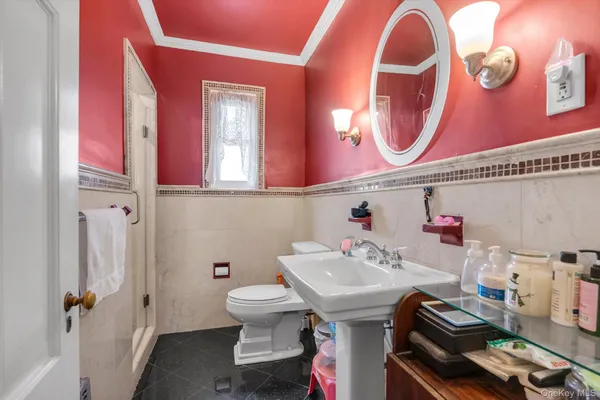 a bathroom with a sink a toilet and a mirror