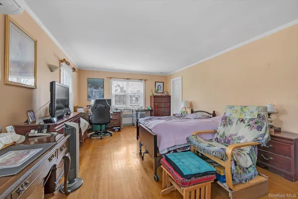 a bedroom with furniture and a window