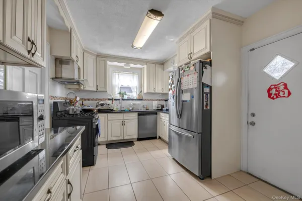 a kitchen with stainless steel appliances granite countertop a refrigerator sink and cabinets