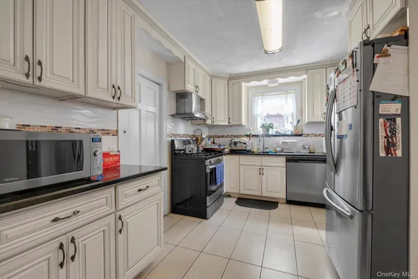 a kitchen with a sink cabinets and stainless steel appliances