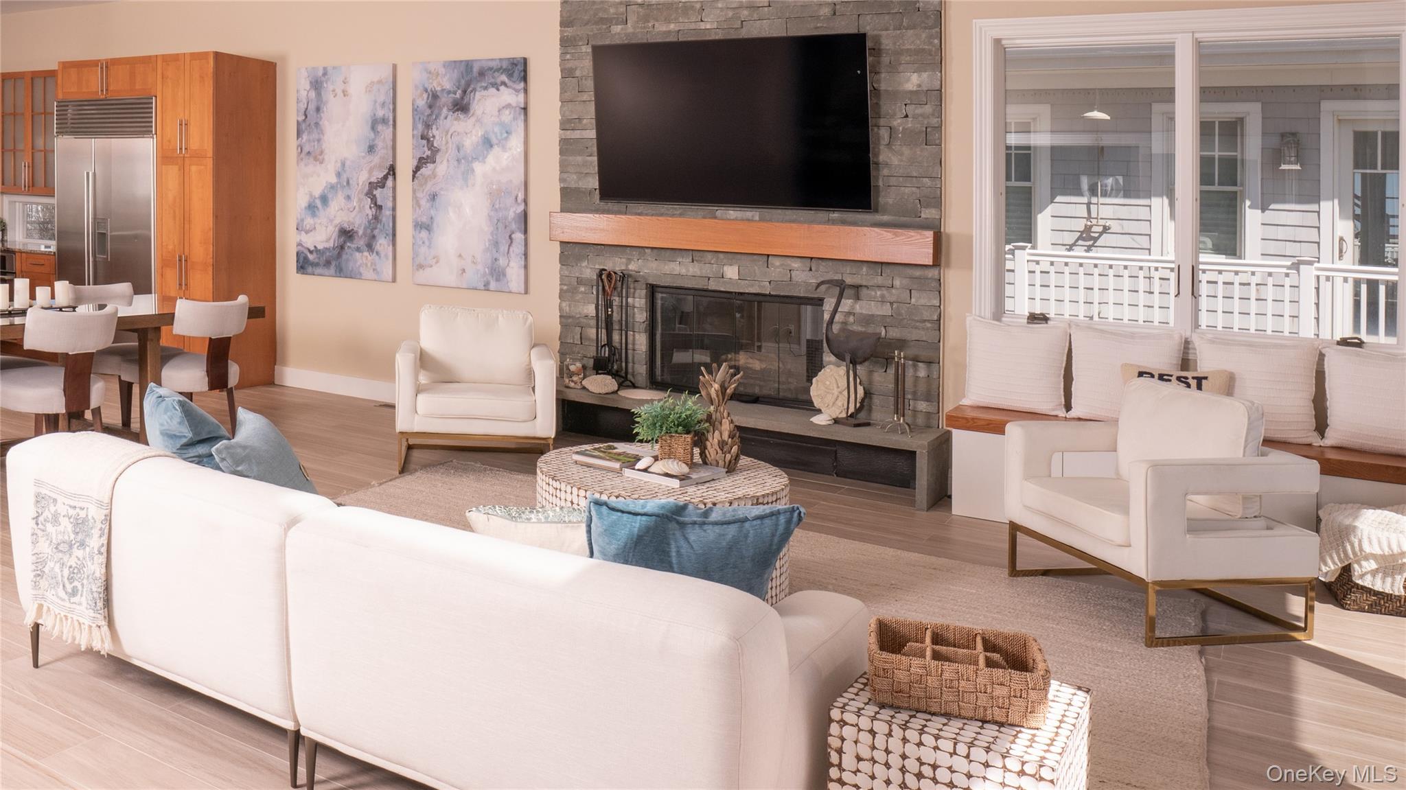 825 Dune Road Westhampton Beach, NY 11978 - Photo 17 of 50 a living room with furniture a flat screen tv and a fireplace