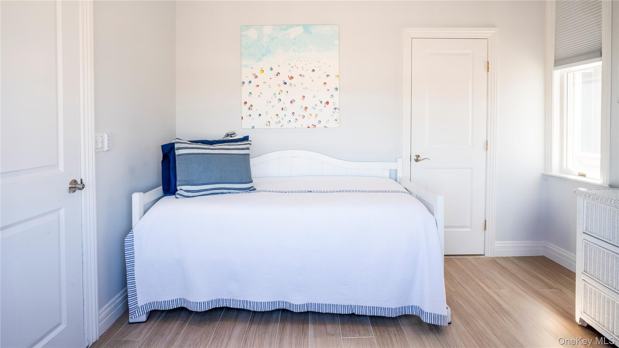 825 Dune Road Westhampton Beach, NY 11978 - Photo 20 of 50 a bedroom with a bed and wooden floor