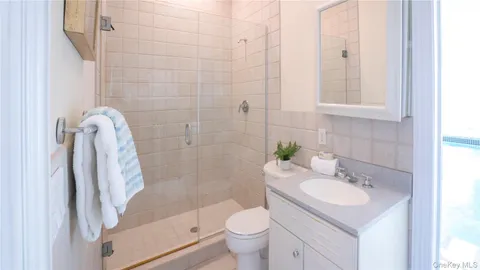 a bedroom with a bed and a night stand