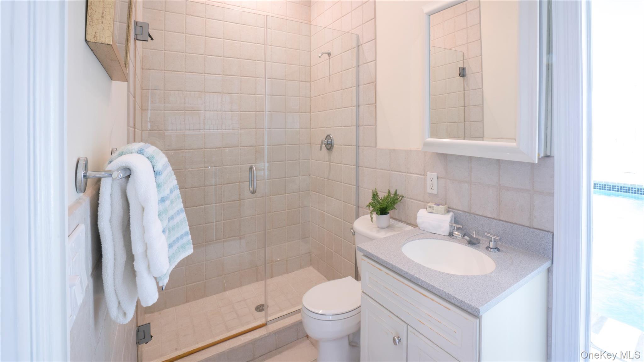 825 Dune Road Westhampton Beach, NY 11978 - Photo 21 of 50 a bathroom with a sink toilet and shower