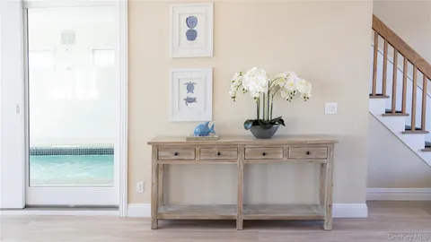 a view of a balcony with wooden floor and outdoor seating