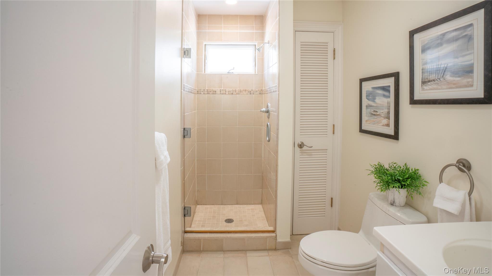 825 Dune Road Westhampton Beach, NY 11978 - Photo 37 of 50 a bathroom with a toilet a sink and shower