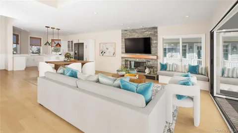 a living room with furniture wooden floor and a flat screen tv