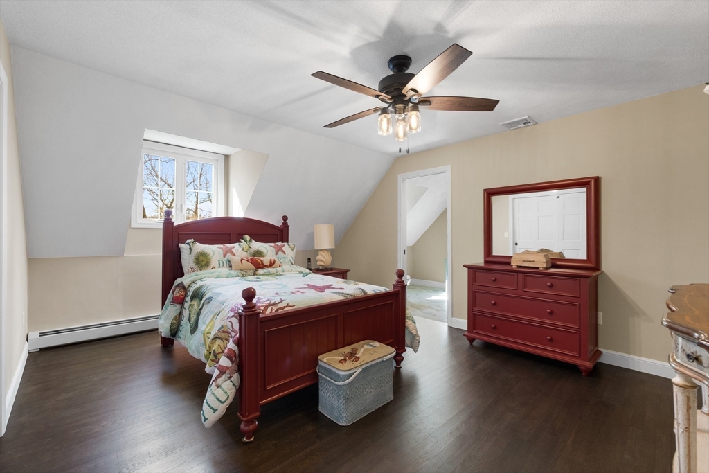 71 Porter Road Boxford, MA 01921 - Photo 18 of 37 a bedroom with a bed and a chandelier