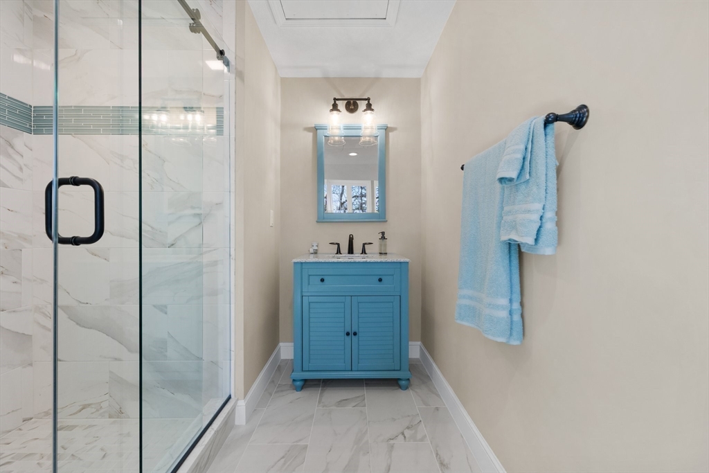 71 Porter Road Boxford, MA 01921 - Photo 19 of 37 a bathroom with a granite countertop sink a shower and a mirror