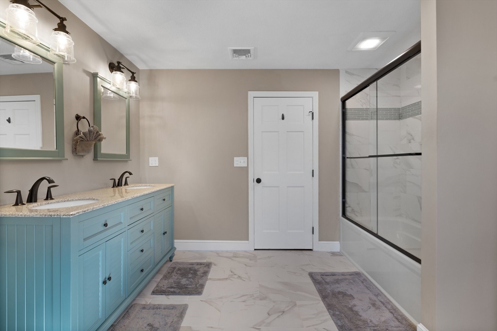 71 Porter Road Boxford, MA 01921 - Photo 22 of 37 a bathroom with a double vanity sink and mirror