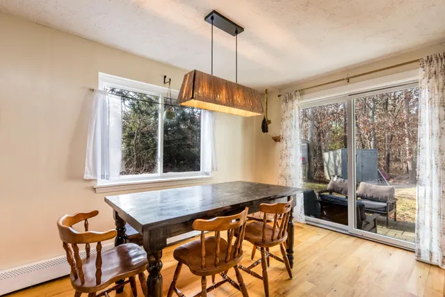 a view of a dining room with furniture wooden floor and a chandelier