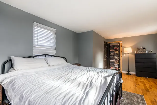 a bedroom with a bed and a dresser