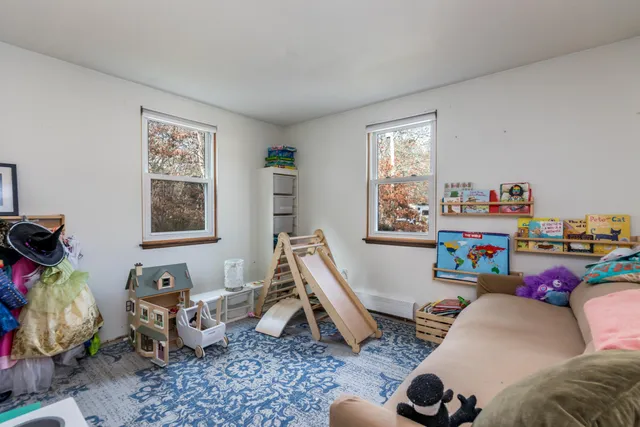 a bedroom with furniture toys and a window