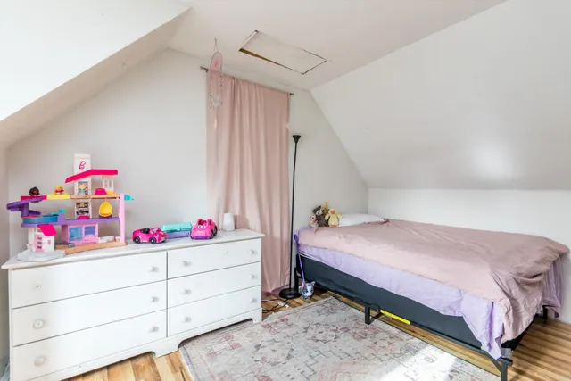 a bedroom with a bed closet and a window