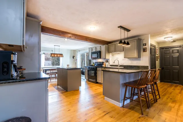 a living room with stainless steel appliances kitchen island granite countertop furniture and a kitchen view