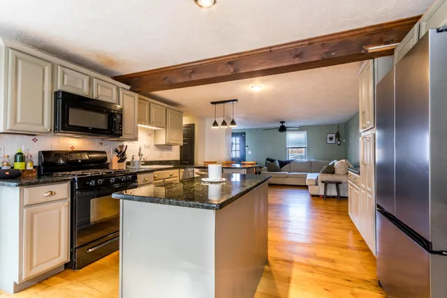 a kitchen with a sink appliances and cabinets
