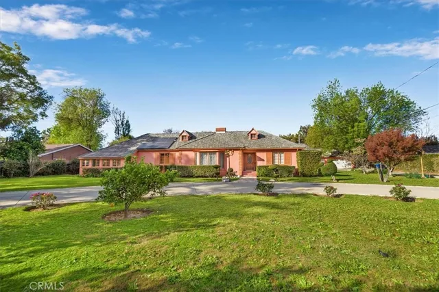 a view of a big yard with a house in the background
