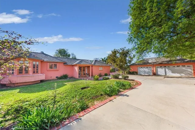 a front view of a house with a yard and pathway