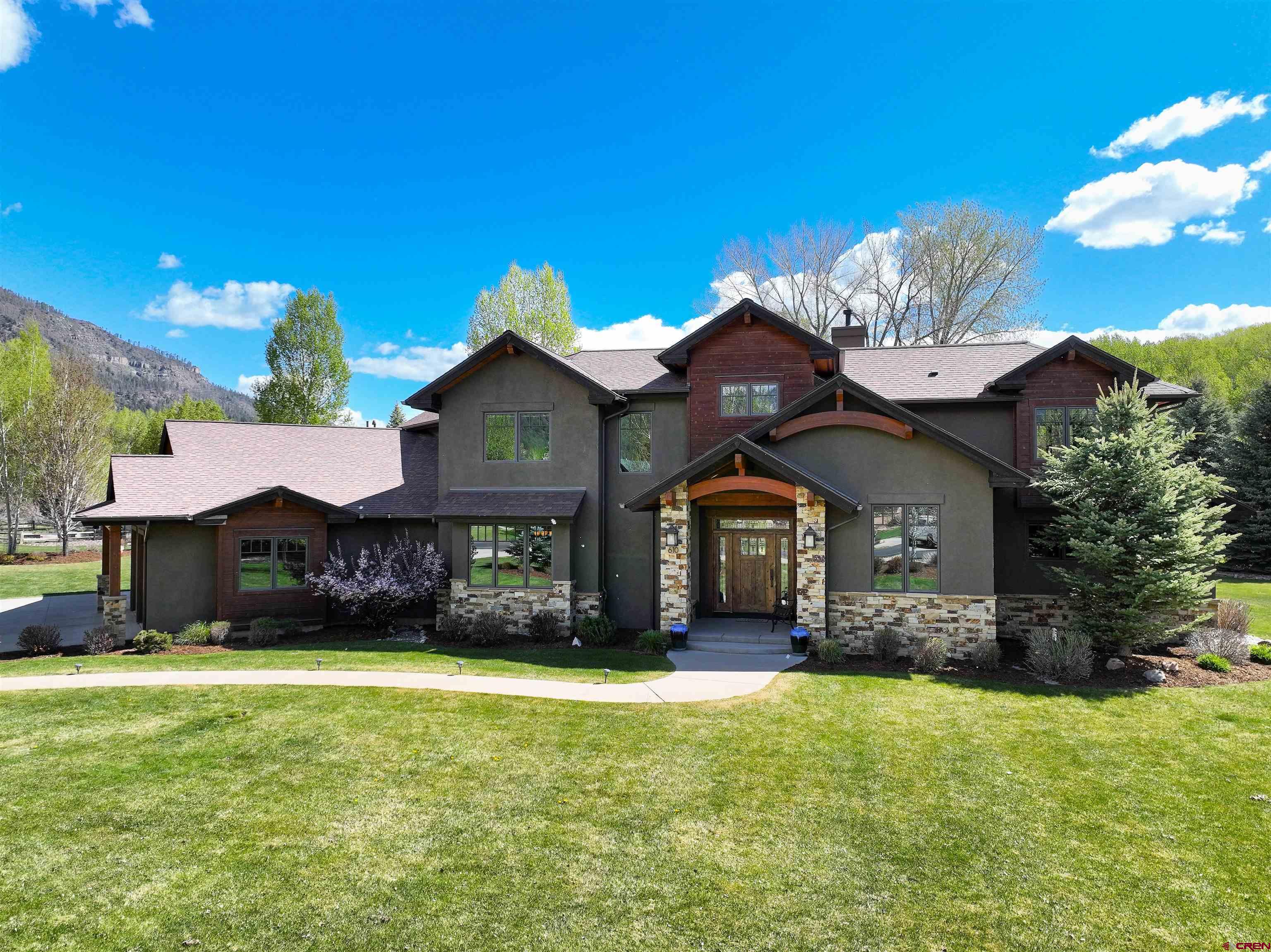 610 Red Rock Road Durango, CO 81301 - Photo 3 of 35 a front view of a house with a yard