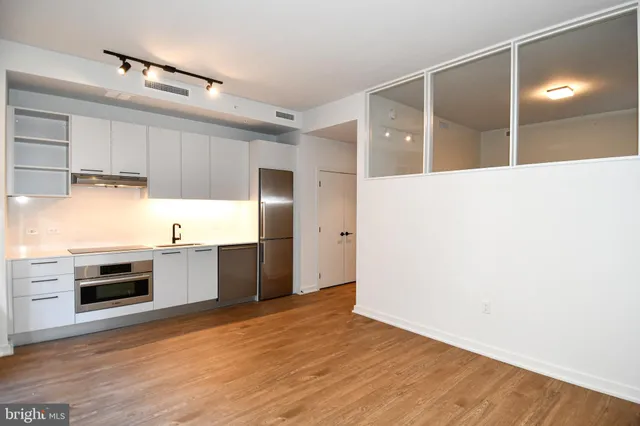 a large kitchen with cabinets and stainless steel appliances