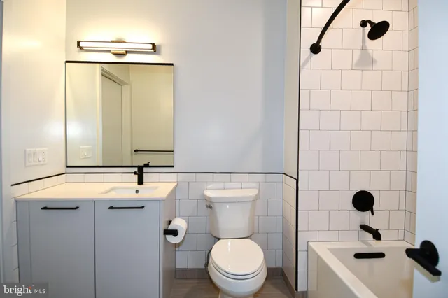 a bathroom with a toilet sink and shower