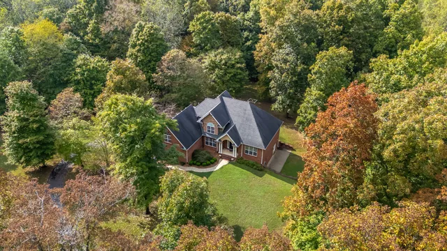 an aerial view of a house with a yard