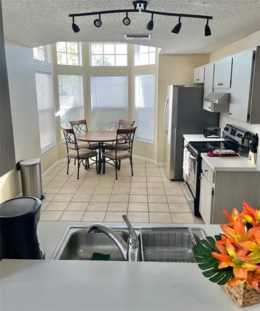 a bathroom with a double vanity sink mirror and bathtub