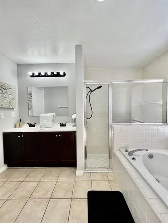 a bedroom with a bed and a ceiling fan