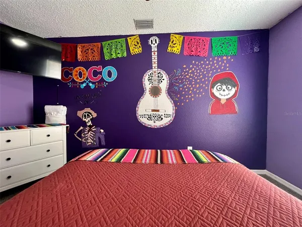 a bedroom with a bed and a chandelier