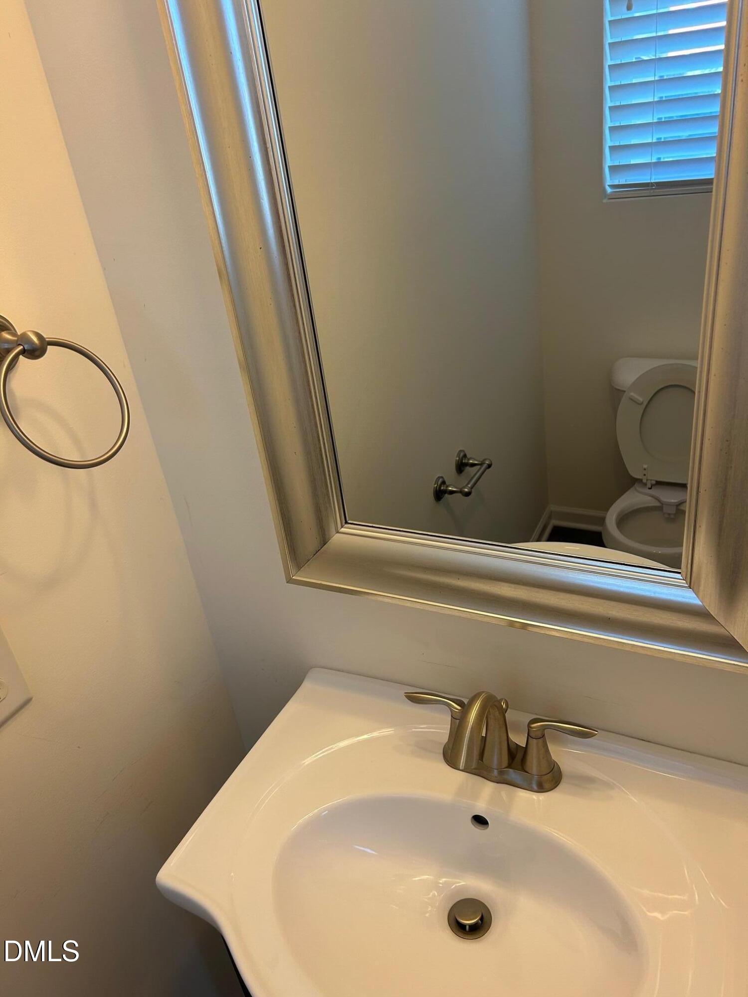 4110 Sykes Street Cary, NC 27519 - Photo 14 of 29 a bathroom with a sink and a mirror