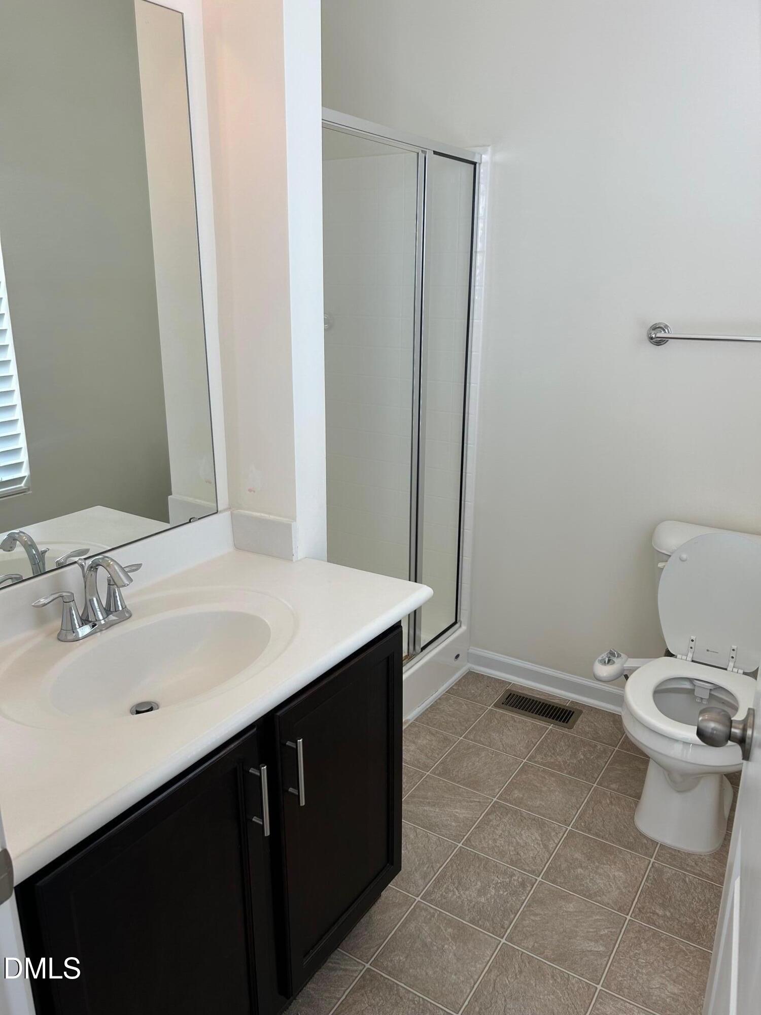 4110 Sykes Street Cary, NC 27519 - Photo 24 of 29 a bathroom with a sink a toilet and a mirror