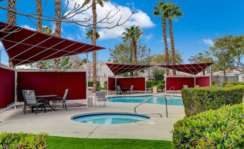 7885 West Flamingo Road, Unit 1008 Las Vegas, NV 89147 - Photo 10 of 29 Relax in the refreshing community pool and spa surrounded by lush landscaping.