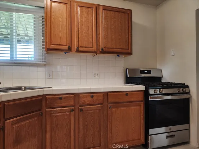 a kitchen with stainless steel appliances granite countertop wooden cabinets a sink and dishwasher