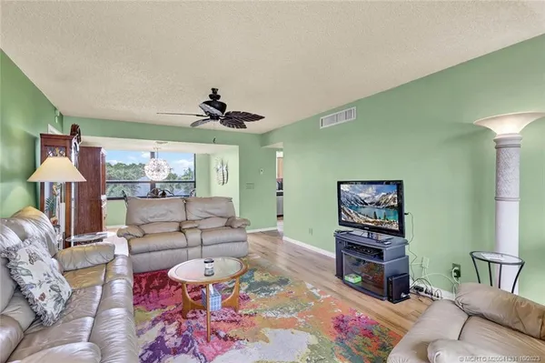 a living room with furniture and a chandelier