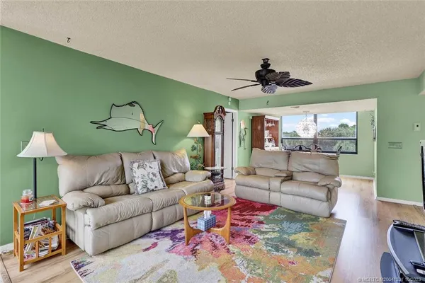 a living room with furniture and a chandelier