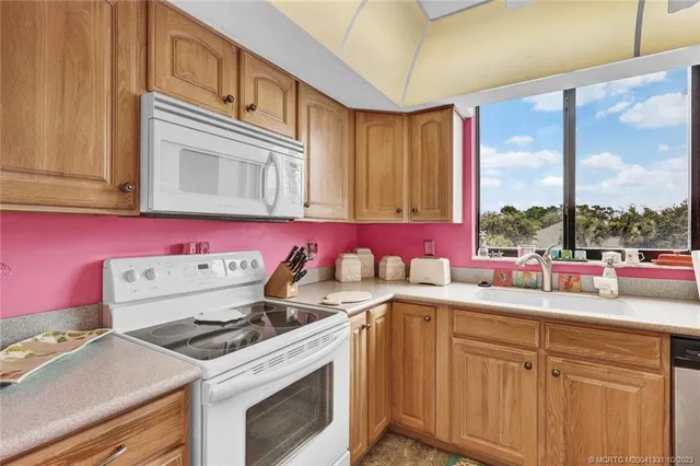 a kitchen with a stove a sink and a refrigerator
