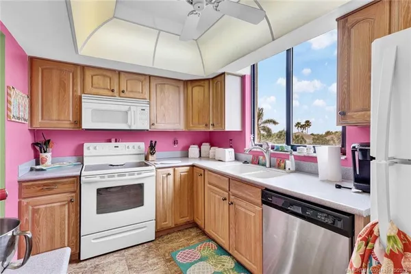 a kitchen with a stove sink and cabinets