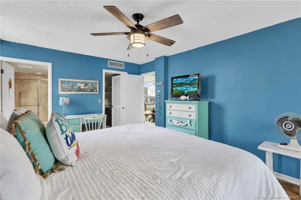 a bedroom with a bed dresser and a window