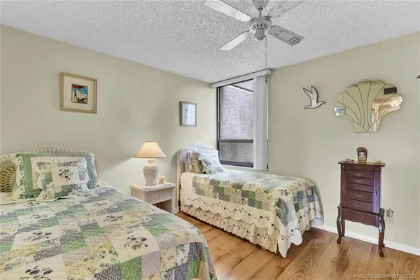 a bedroom with two beds and painting on the wall